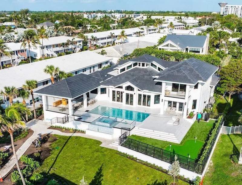 Aerial view of luxury estate home with pool, patio, and professional landscape installation in Palm Beach County-1