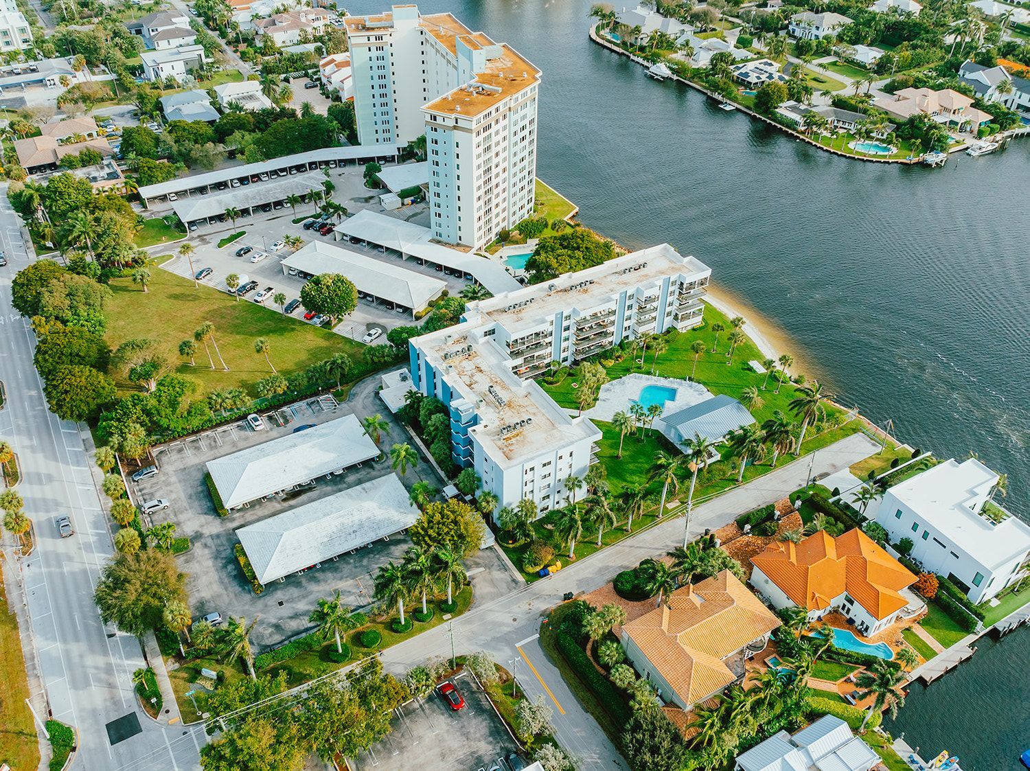 Aerial view of waterfront HOA community with professional commercial landscaping maintenance in Palm Beach, FL