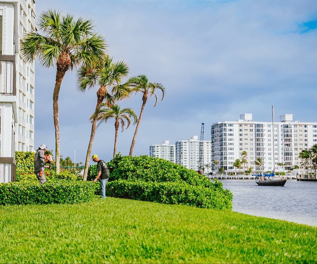 Commercial landscape maintenance crews servicing an HOA property in Boynton Beach, FL-1