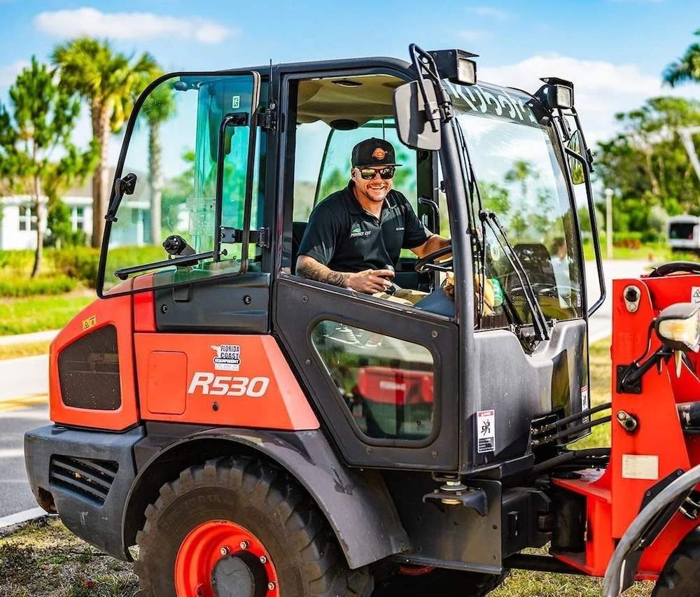 Perfect Cut team member operating commercial landscaping equipment in Boynton Beach, FL-1
