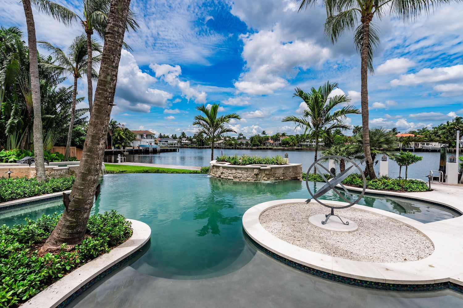 Waterfront luxury pool and tropical landscape design at estate home in Boca Raton FL