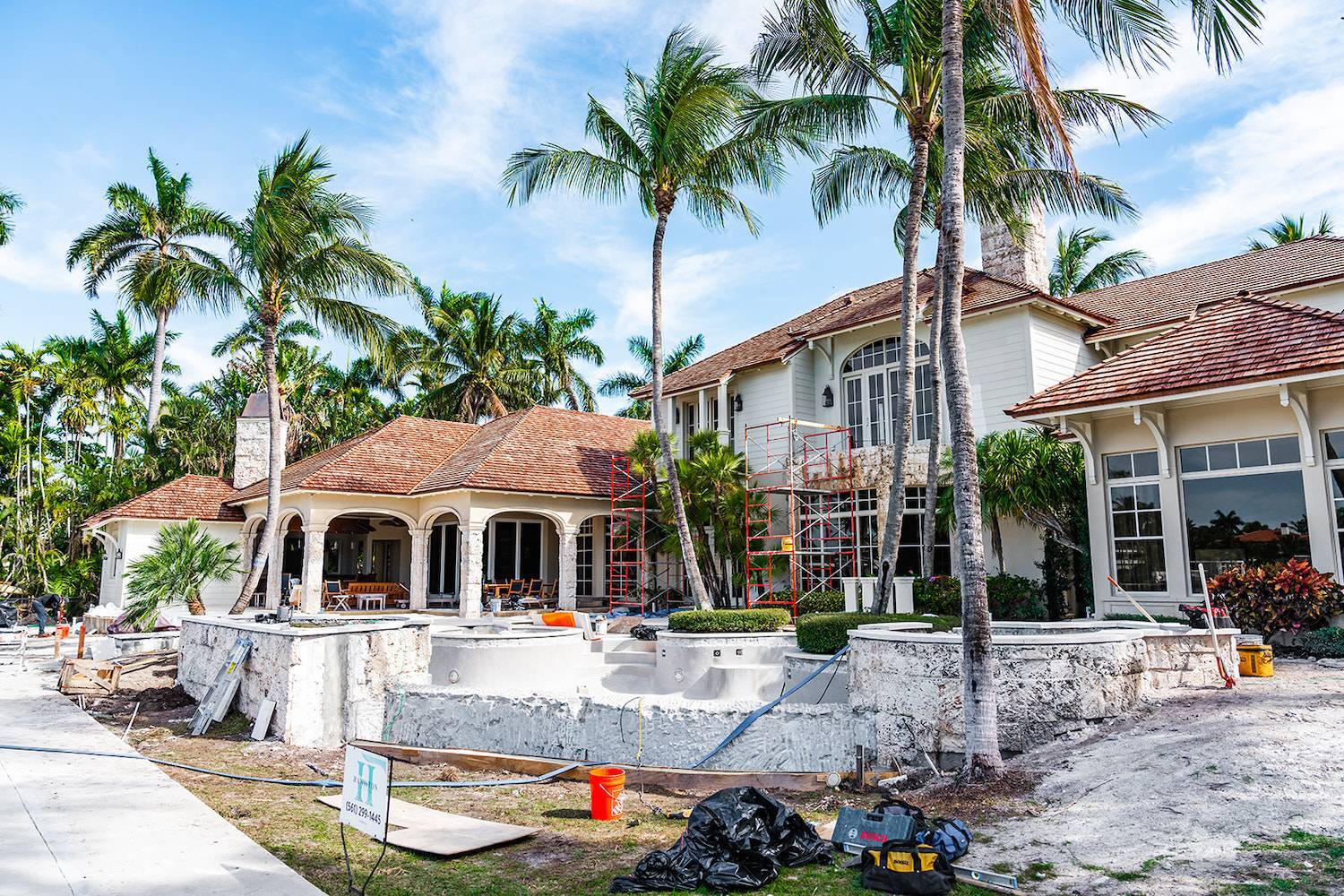 Estate renovation in progress with landscape construction and pool installation in Palm Beach, FL