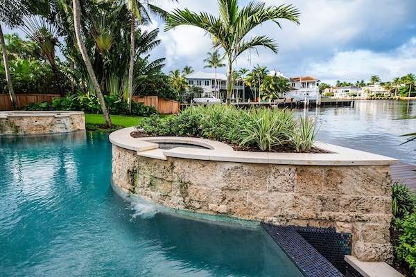 Luxury backyard with pool, palm trees, and landscape company installation in Delray Beach, FL-1