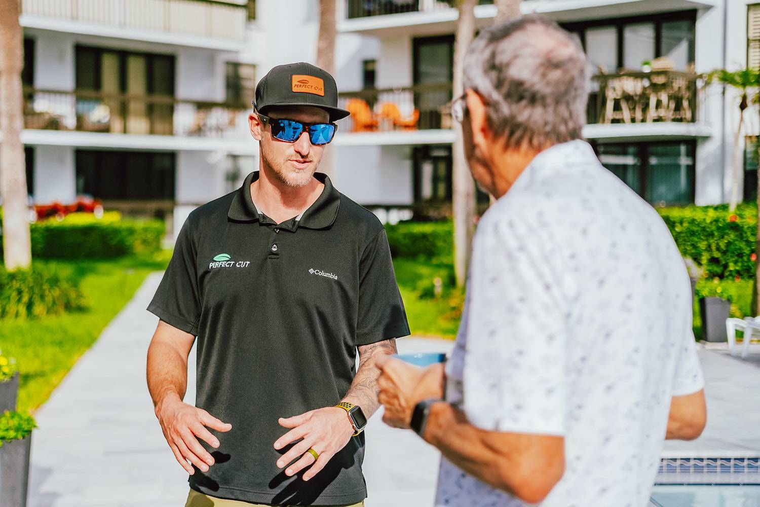 Perfect Cut team member discussing estate management and landscape services in Palm Beach, FL