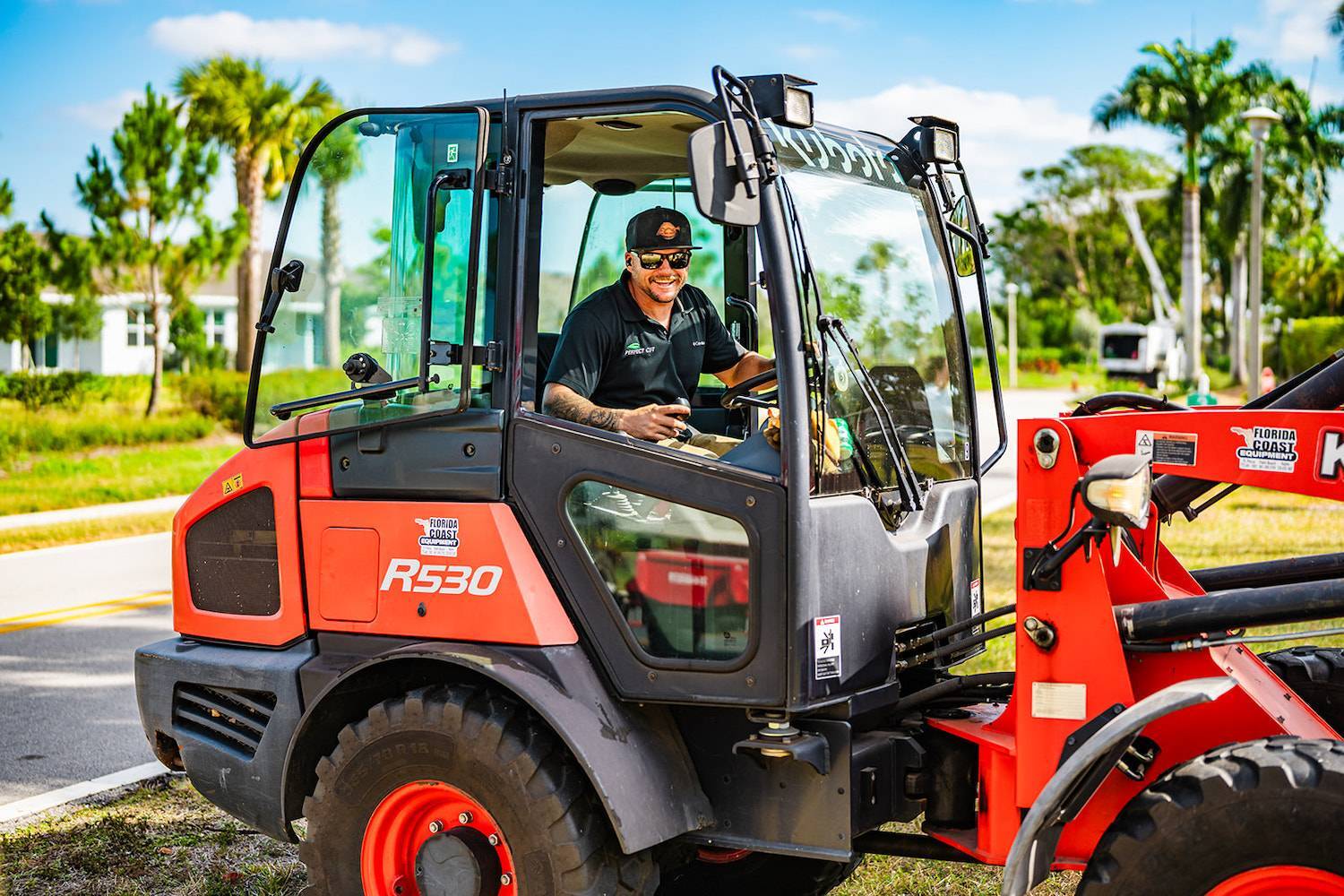 Perfect Cut team member operating commercial landscaping equipment in Boynton Beach, FL