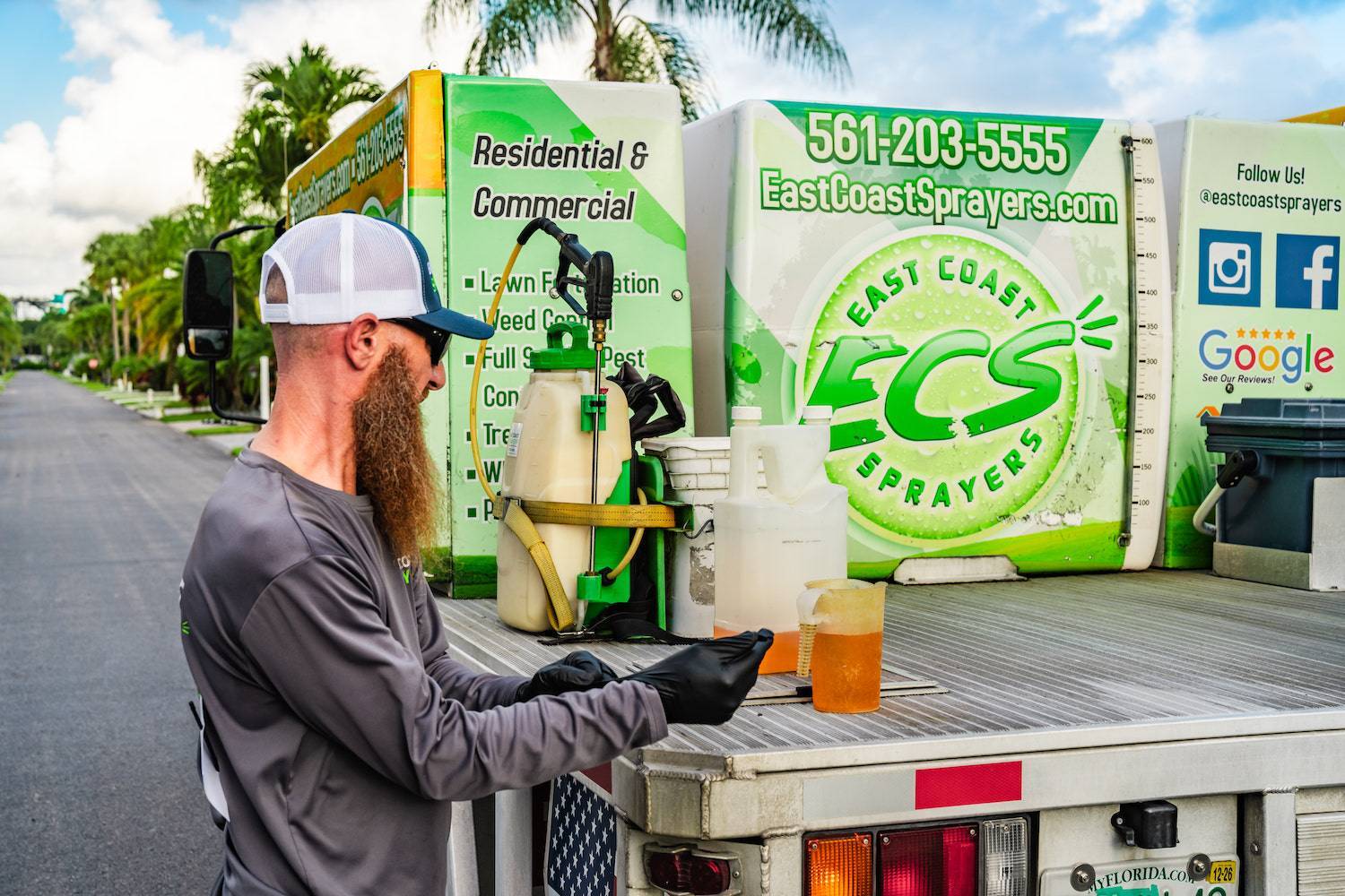 Technician preparing lawn treatment solution for landscape services in Delray Beach, FL